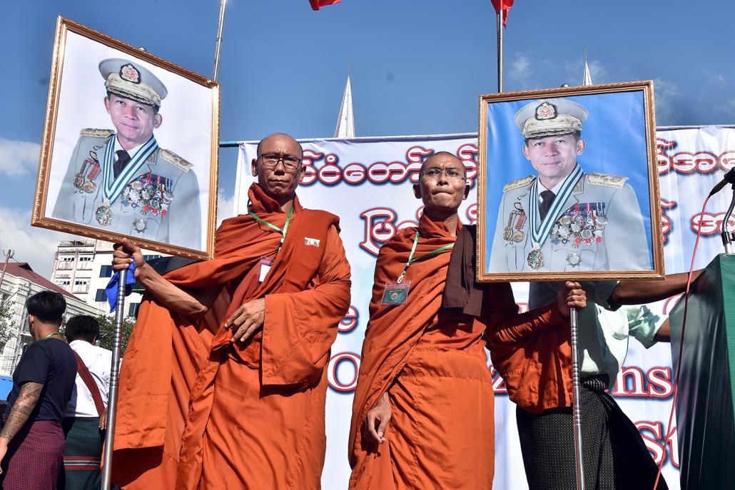 Monks hold images of Senior General Min Aung Hlaing during a pro-Tatmadaw rally in Yangon on October 14, 2018. (Steve Tickner | Frontier)