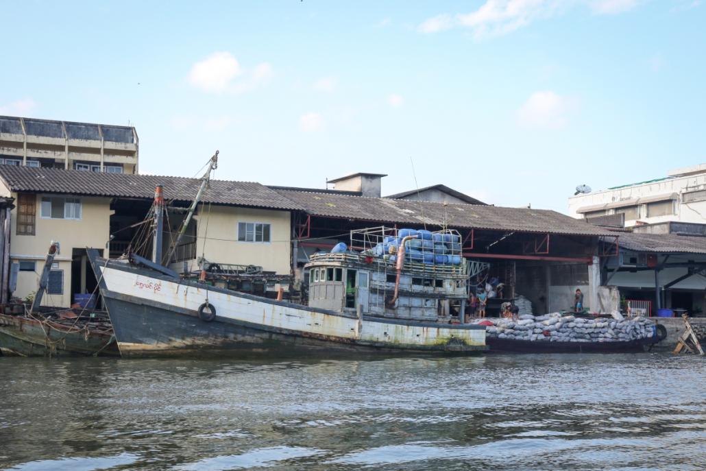 A charcoal warehouse in Ranong, Thailand with boats that transport illegal charcoal products. (Victoria Milko | Mongabay)