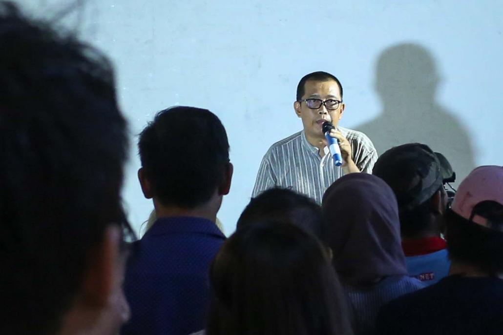 "Seven Decades" curator Htein Lin addresses the crowd during the opening of the show on July 7. (Victoria Milko | Frontier)