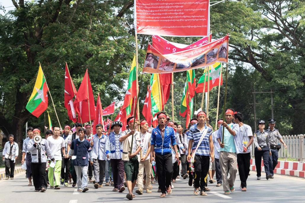 Banners at the demonstration in Myitkyina on June 3 display demands directed at the KIA/KIO and photographs of landmine victims. (Phoe Shane | Frontier)