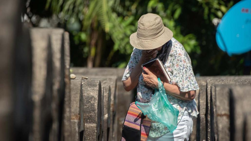 Ms Mozelle Friedman walks through Yangon's Jewish cemetery. After locating the grave of her great-grandmother, she said a prayer and wept. (Rajiv Raman | Frontier)