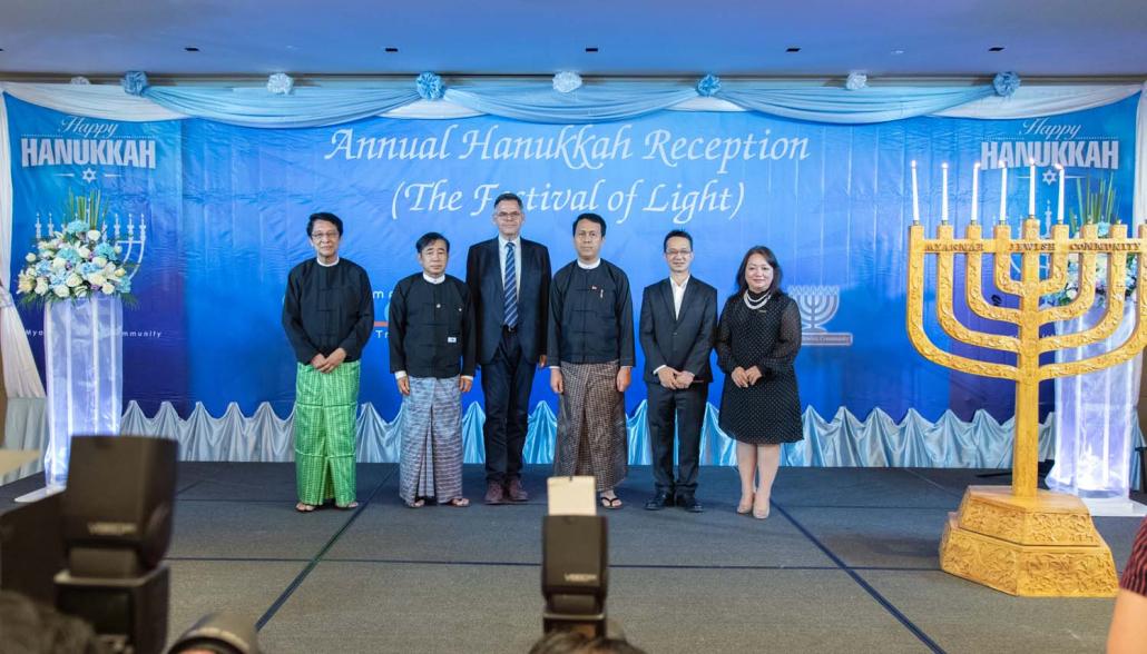 Samuel "Sammy" Samuels (second right) poses for a photo together with Yangon Region Chief Minister U Phyo Min Thein (third right) and Israel's ambassador to Myanmar Mr Ronen Gilor (third left) at an event to mark Hanukkah. (Rajiv Raman | Frontier) 