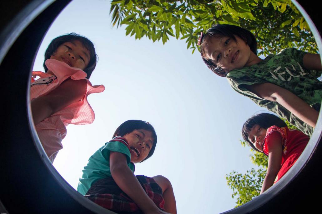 Children enjoy the playground in Gyo Gone ward, Insein Township. (Thuya Zaw | Frontier)