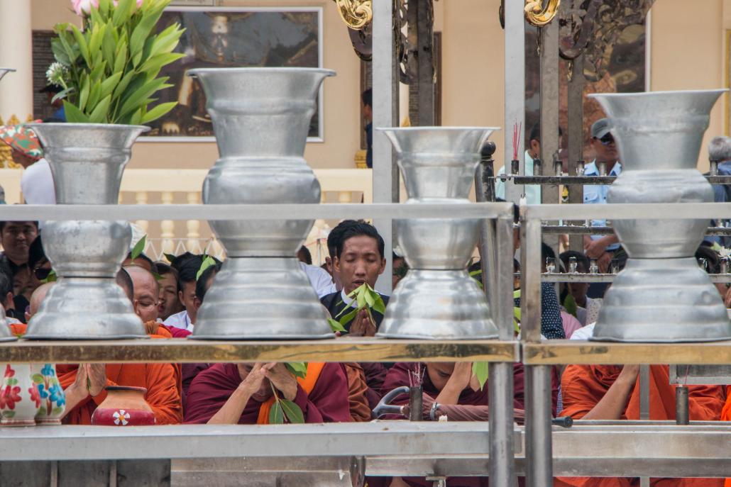 Ko Win Ko Ko Latt (centre, in black jacket and white collar) prays for U Wirathu at Yangon's Shwedagon pagoda on May 30. (Thuya Zaw | Frontier)