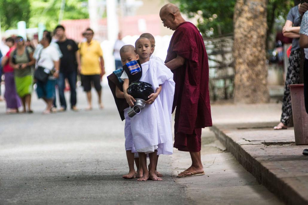 Young phoethudaw (followers) prepare to help collect alms in the morning. (Teza Hlaing / Frontier)