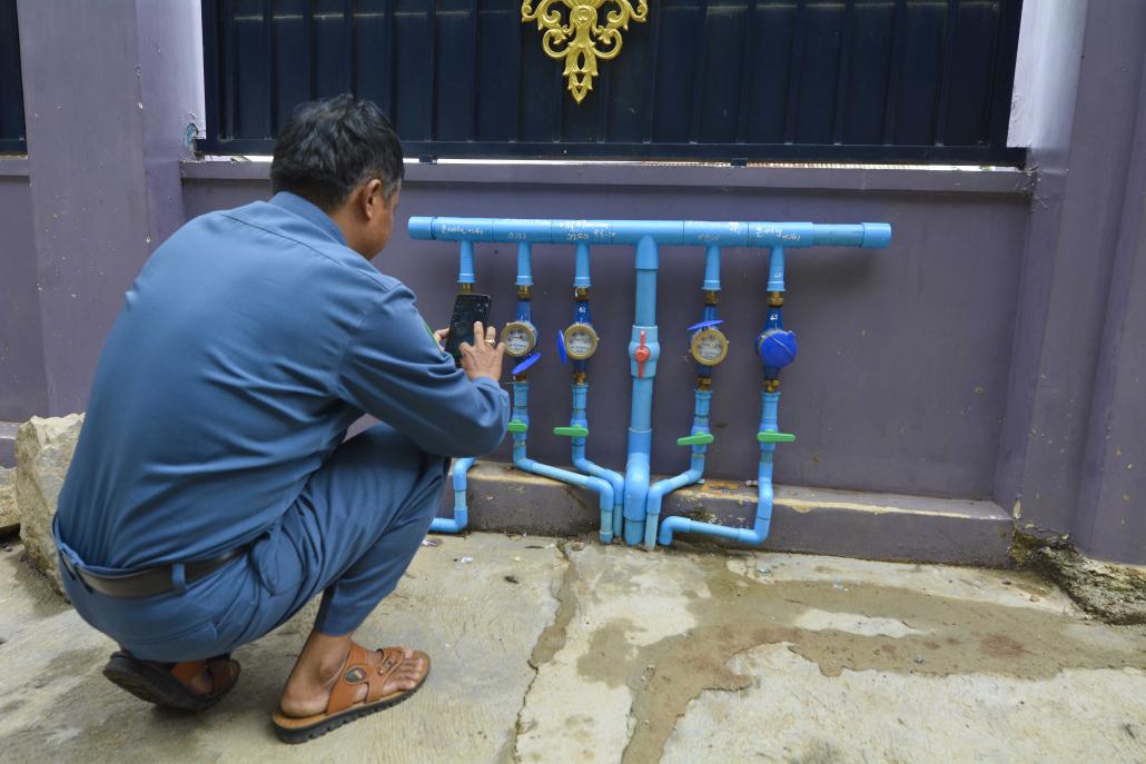 An official uses the application on a water meter in Taunggyi. (Teza Hlaing | Frontier)