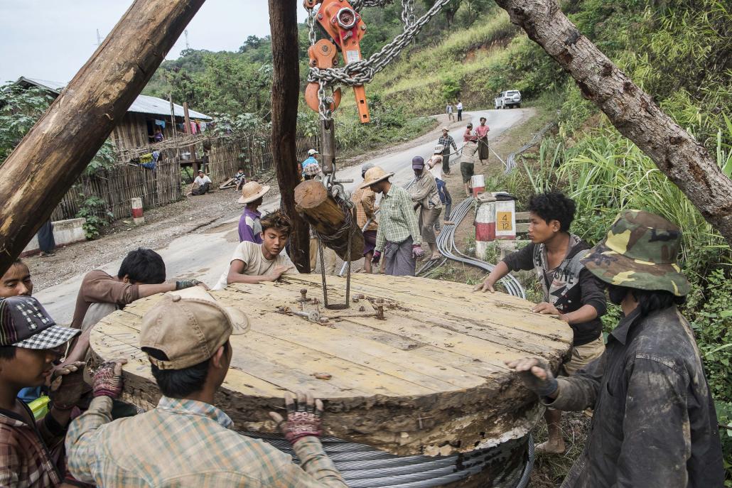 Men work on Myanmar's national electricity grid in Magway Region. (Teza Hlaing / Frontier)