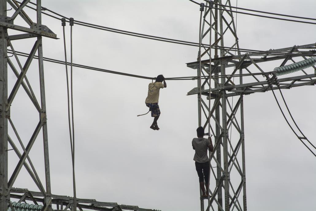 Men work on Myanmar's national electricity grid in Magway Region. (Teza Hlaing / Frontier)