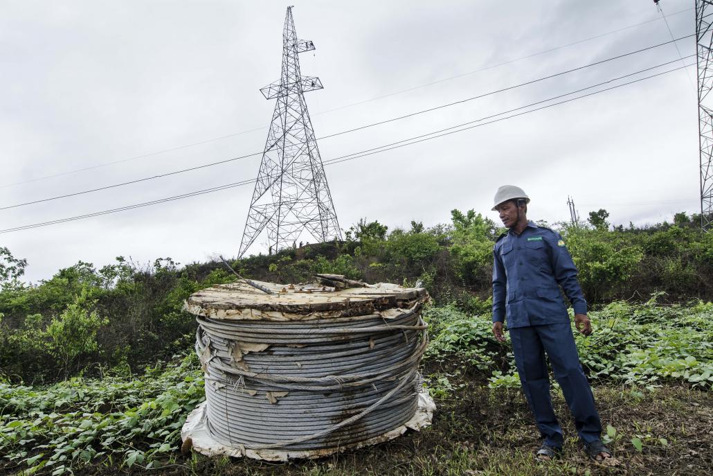 Men work on Myanmar's national electricity grid in Magway Region. (Teza Hlaing / Frontier)