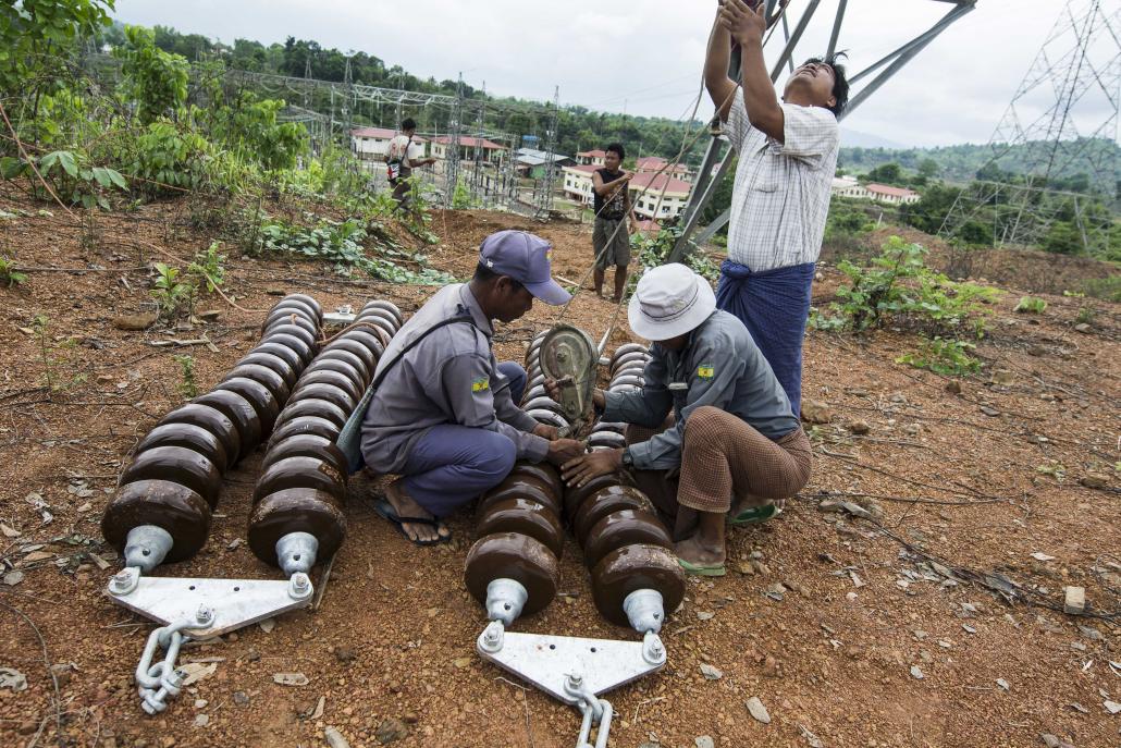 Men work on Myanmar's national electricity grid in Magway Region. (Teza Hlaing / Frontier)