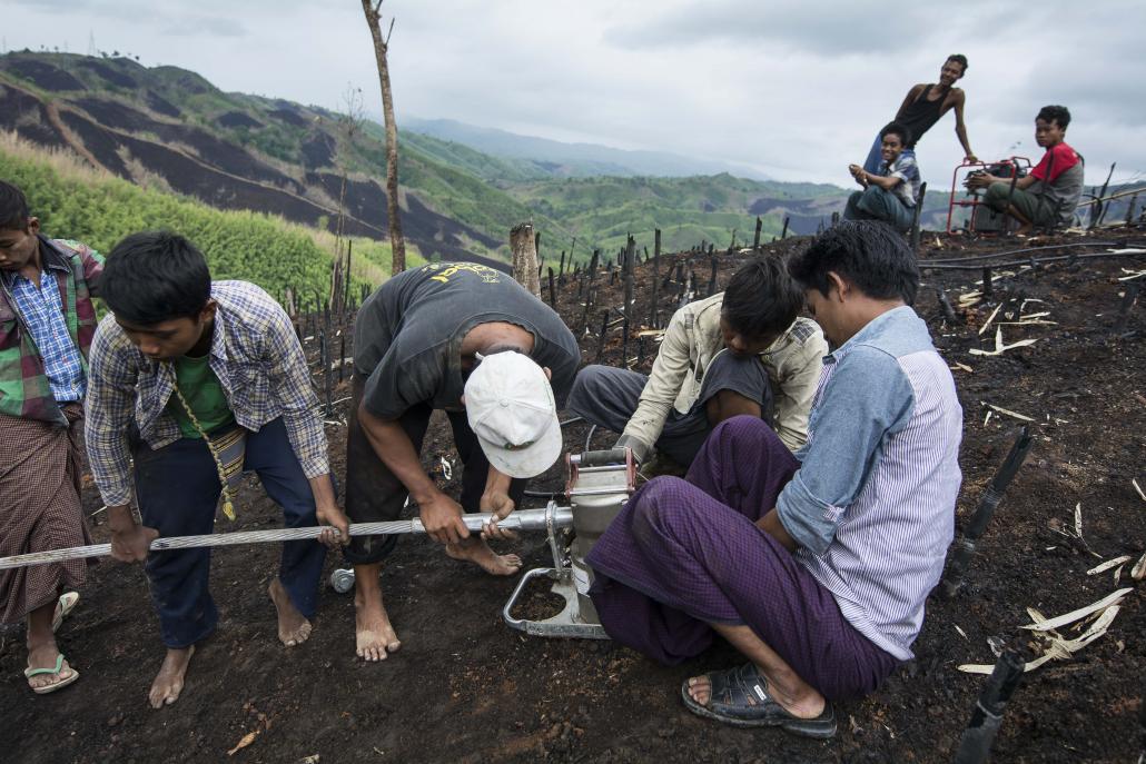 Men work on Myanmar's national electricity grid in Magway Region. (Teza Hlaing / Frontier)