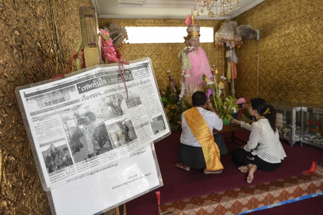 The entrance to Bo Bo Gyi's shrine at Botahtaung Pagoda. The news article, from a Thai paper, makes mention of the nat's apparent role in securing Leicester City's Premier League victory. (Teza Hlaing / Frontier)