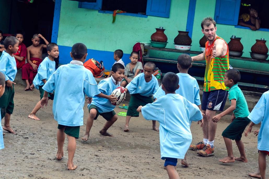 The author tries to explain the offside rule to the children at Nan Oo, to no avail. (Teza Hlaing / Frontier)