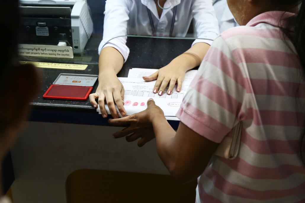 Customers taking out loans from ACLEDA are asked to mark paperwork with a red thumbprint. (Victoria Milko / Frontier)