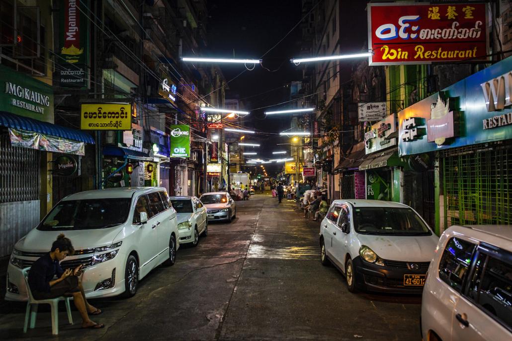 The normally busy 19th Street in Yangon's Chinatown area has been almost silent since late March, when regional authorities ordered restaurants and bars to serve take-away only. (Hkun Lat | Frontier)