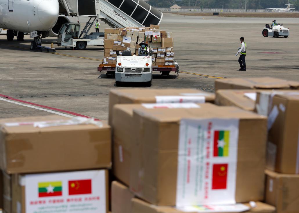 Yangon International Airport staff unload medical supplies brought by a Chinese medical team on April 8 to support Myanmar's COVID-19 response. (AFP)