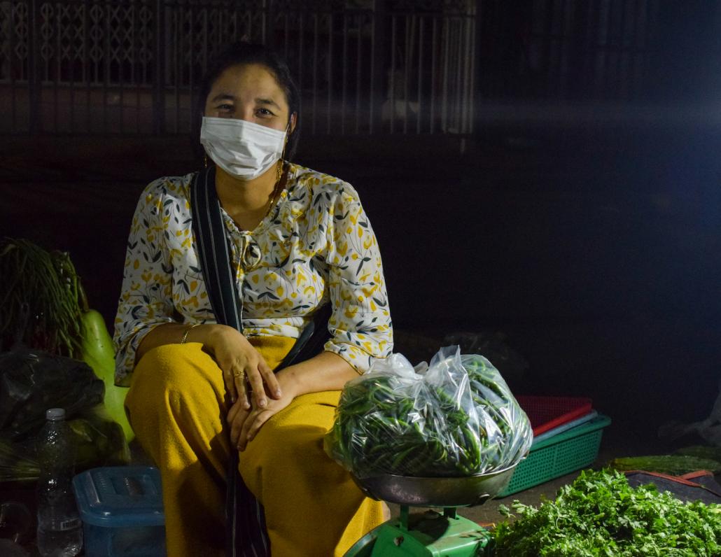 A vendor at the Thingangyun night market on March 26. Workers in the informal sector have little safety net, in part because they do not contribute to the Social Security Fund. (Kyaw Lin Htoon | Frontier)