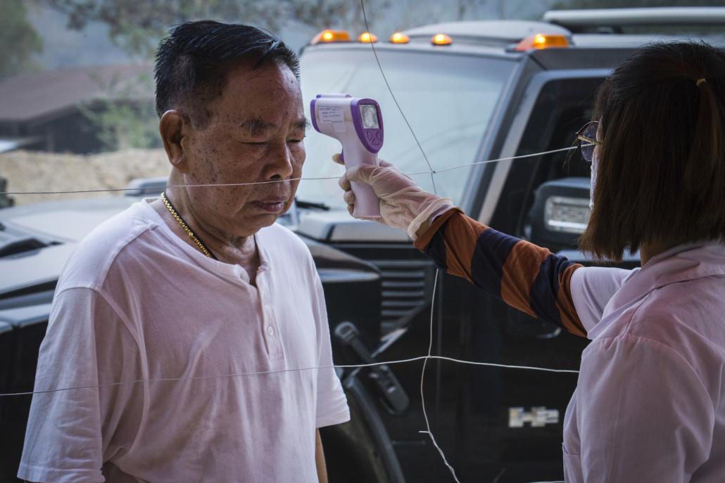 Kachin Independence Organisation leader General N'Ban La has his temperature checked at the entrance to Laiza, the group's headquarters on the Myanmar-China border, on March 31. (Naw Seng I Frontier)