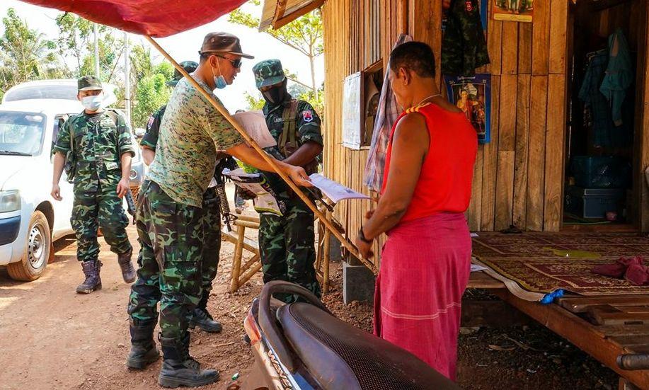 Members of the Karen National Liberation Army, the armed wing of the Karen National Union, hand out information about COVID-19 as part of the group's prevention measures. (Supplied)