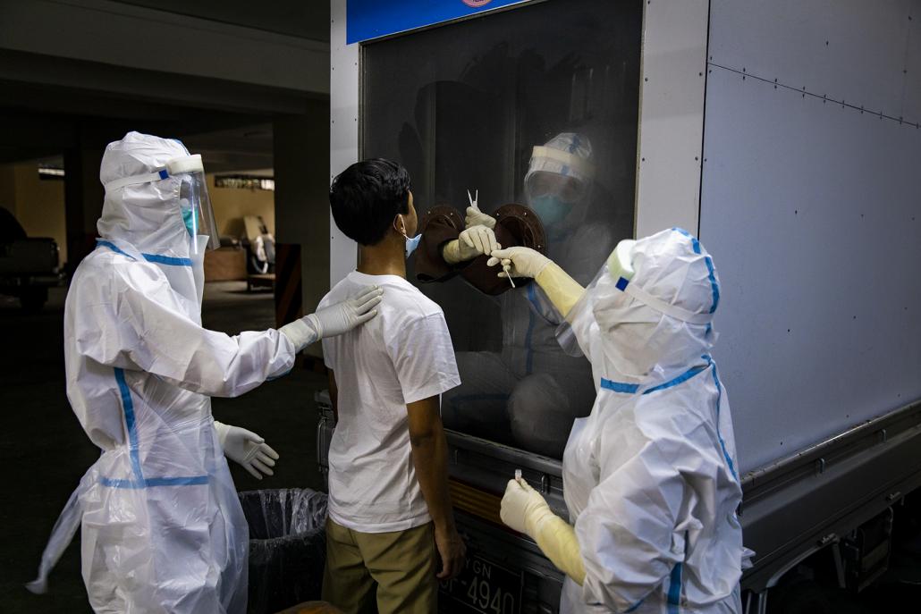 Medical workers swab a person on May 22. (Hkun Lat | Frontier)