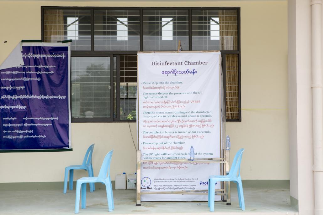 A sign explains how to use a disinfectant chamber. (Thuya Zaw | Frontier)