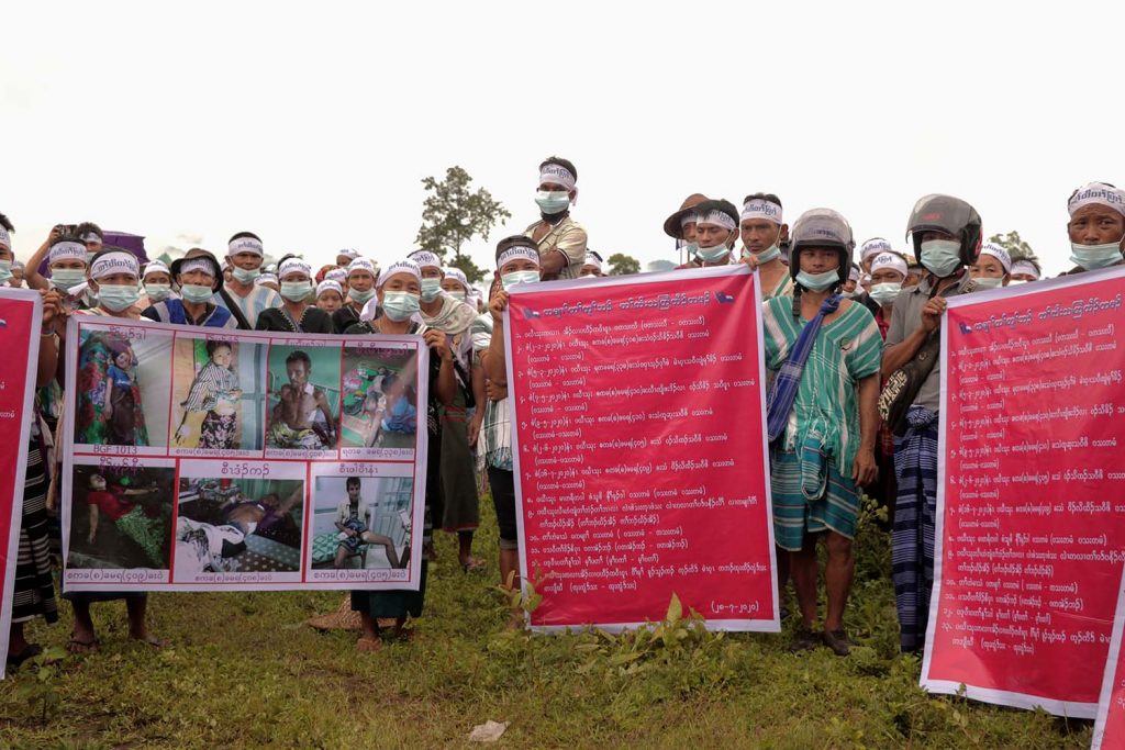 Karen people hold posters and shout slogans during a protest against the Tatmadaw at Papun in Kayin State on July 28 (AFP)