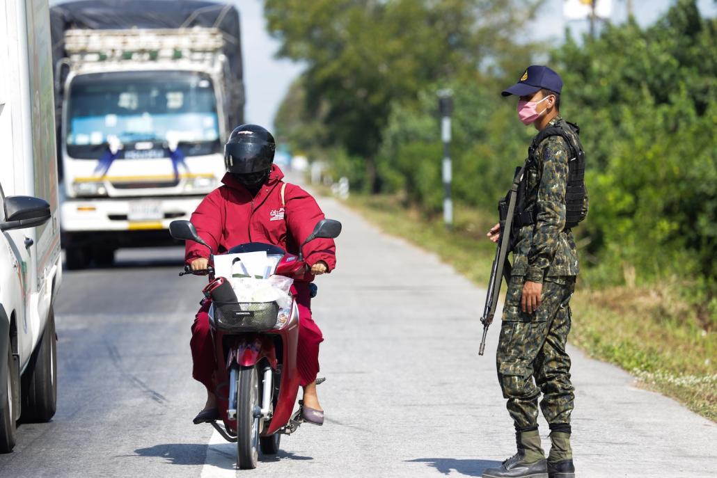 A Thai security official keeps watch at a checkpoint on March 31 after authorities began restricting travel in and out of the southern province of Pattani as a preventive measure against COVID-19. (AFP)