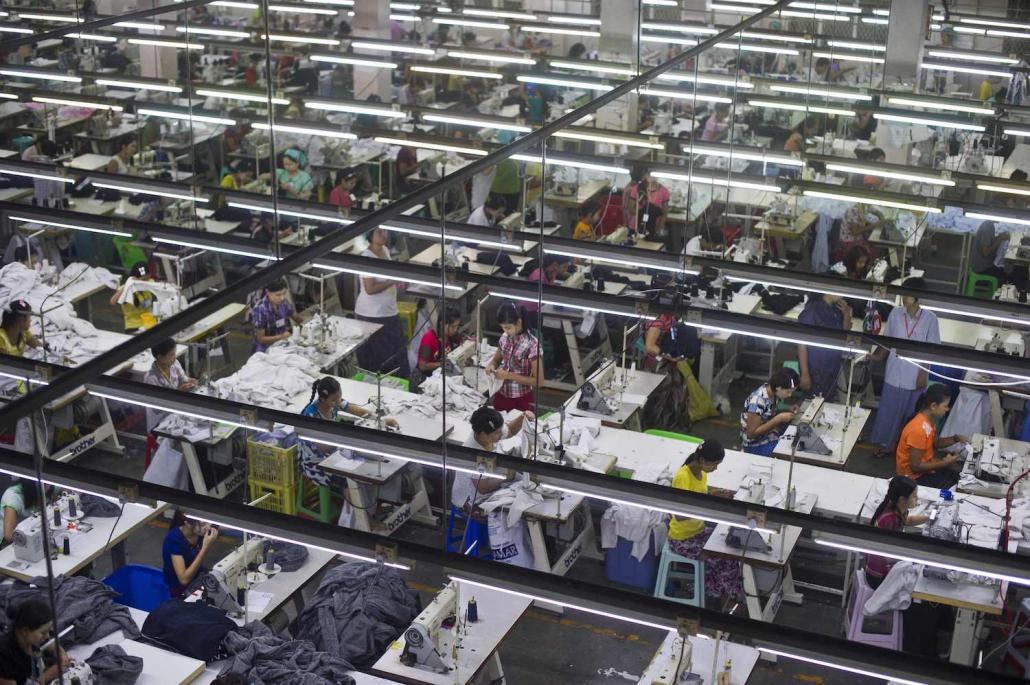 Employees at a garment factory in the Shwe Pyi Thar industrial zone in September 2015. Workers in Yangon's garment sector are thought to send back hundreds of millions of dollars a year to rural communities. (Ye Aung Thu | AFP)