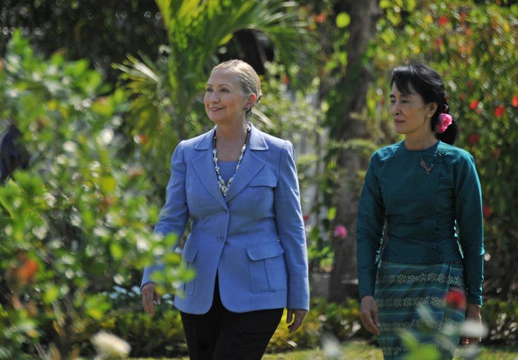 Aung San Suu Kyi and visiting Hillary Clinton tour the grounds of Suu Kyi’s Yangon residence on December 2, 2011. (Soe Than Win / AFP)