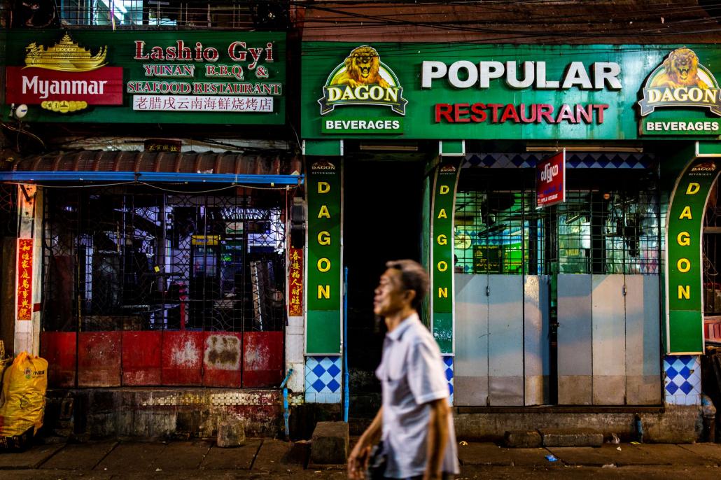 Chinatown's 19th Street, a popular evening haunt for locals and tourists, is now desolate as most Yangon bars comply with new restrictions, despite the lack of enforcement. (Hkun Lat | Frontier)