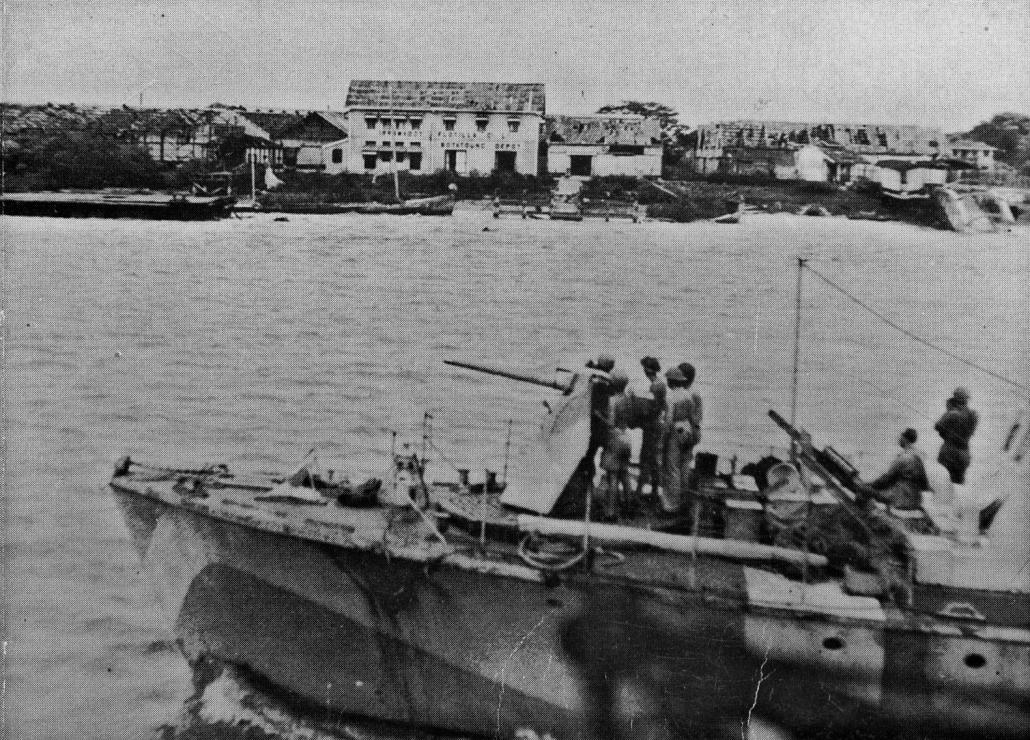 A gunboat entering Rangoon on May 2 passes an Irrawaddy Flotilla Company depot. (Supplied)