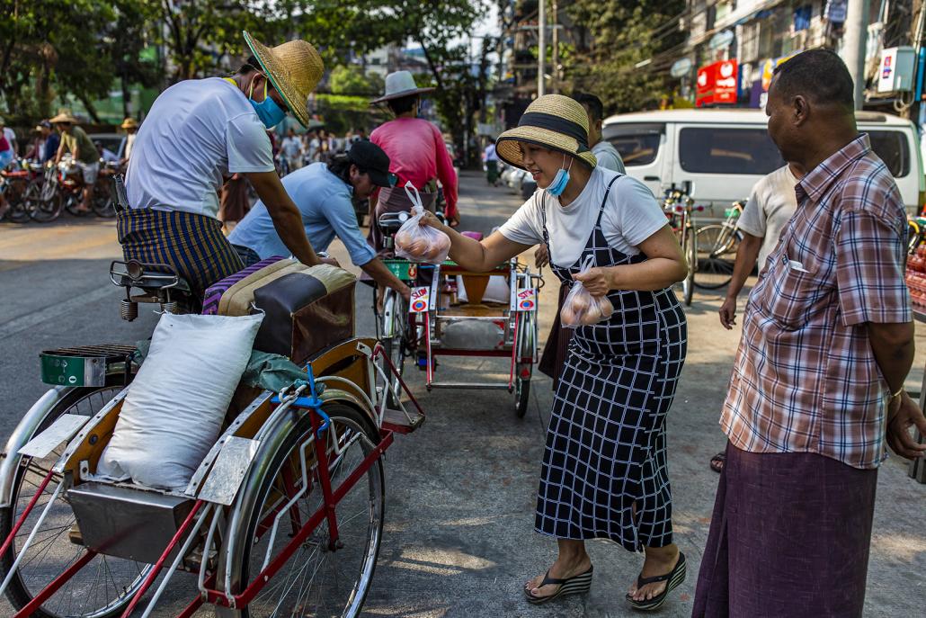 Charity group People to People donates eggs to underemployed trishaw drivers in Sanchaung Township on April 9. (Hkun Lat | Frontier)