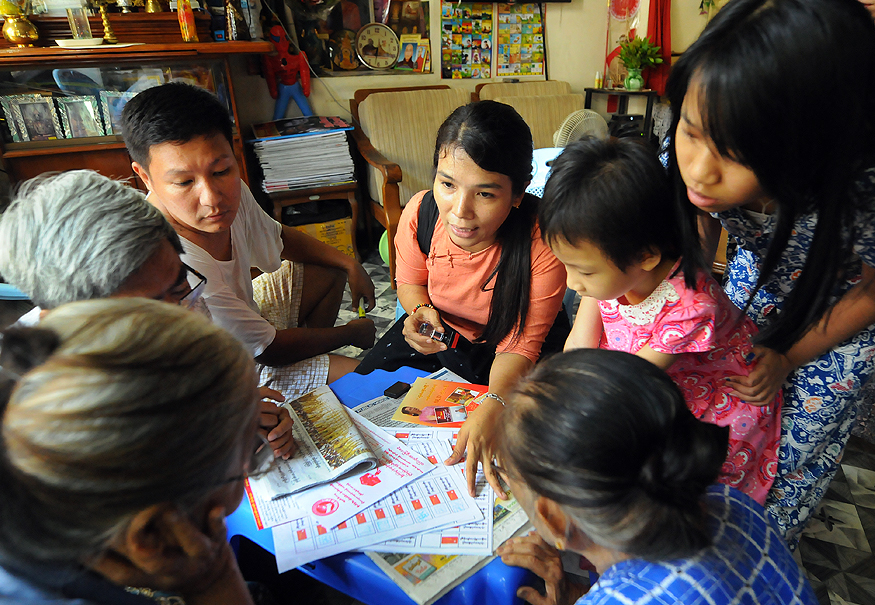 A National League for Democracy member campaigns door-to-door in downtown Yangon's Kyauktada Township in 2015. (Steve Tickner | Frontier)