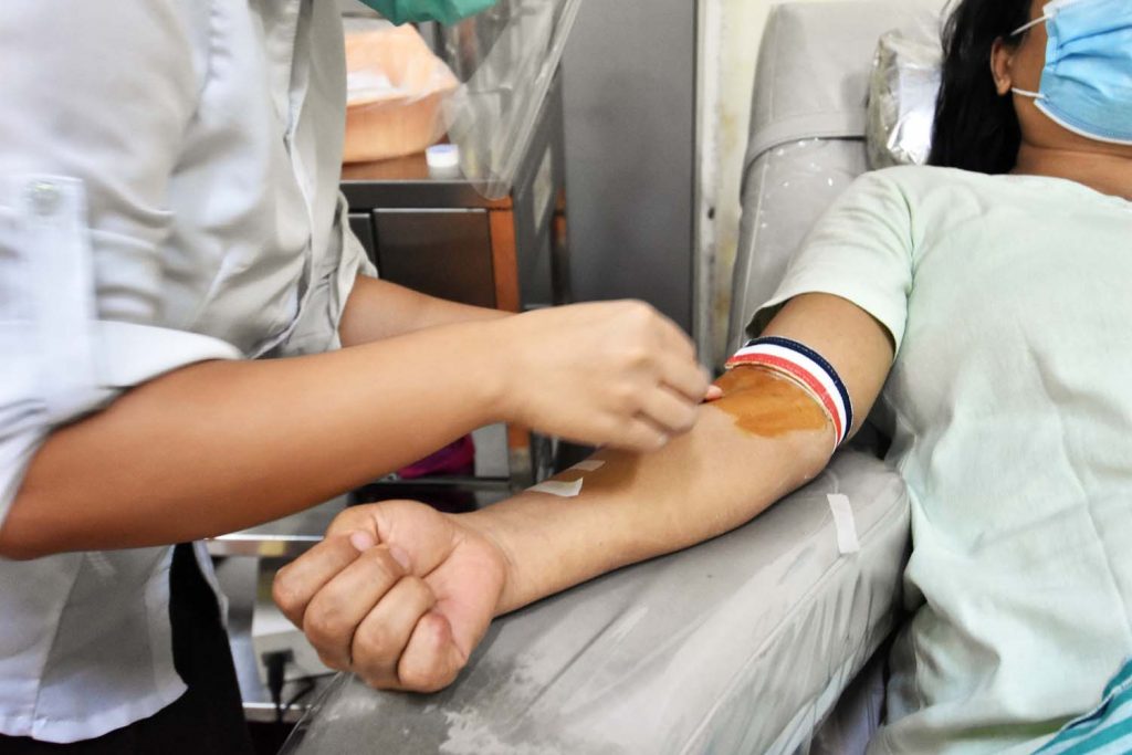 A donor gives blood at the National Blood Center in Yangon on June 2. (Steve Tickner | Frontier)