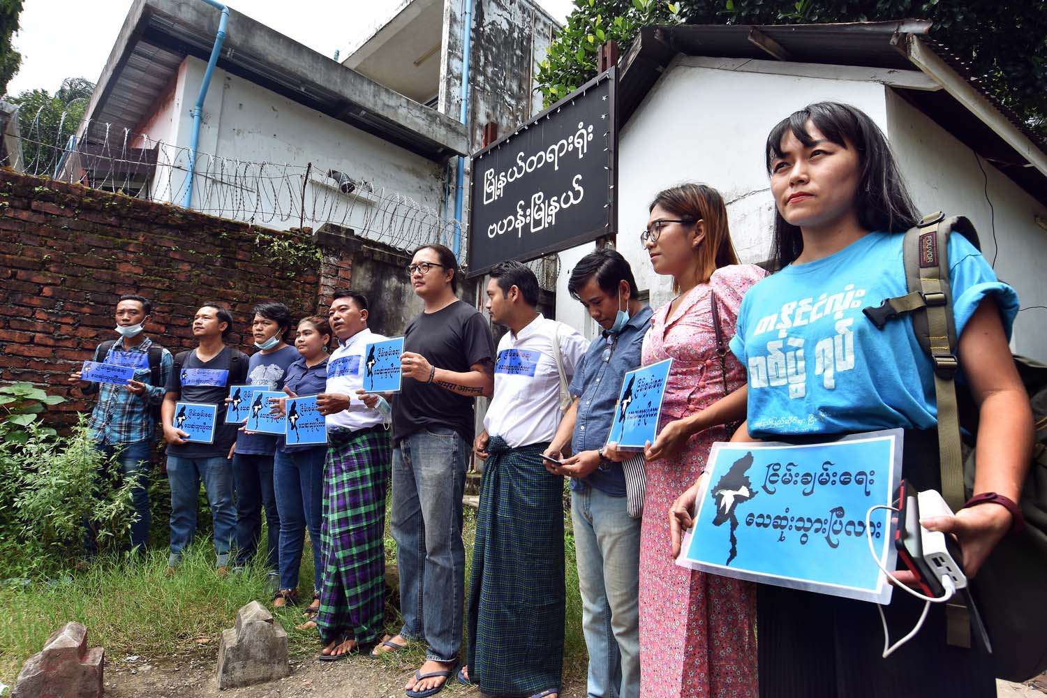 Activists charged over the anti-war rally in Yangon stand outside Bahan Township Court after their conviction for violating a protest law. (Steve Tickner | Frontier)