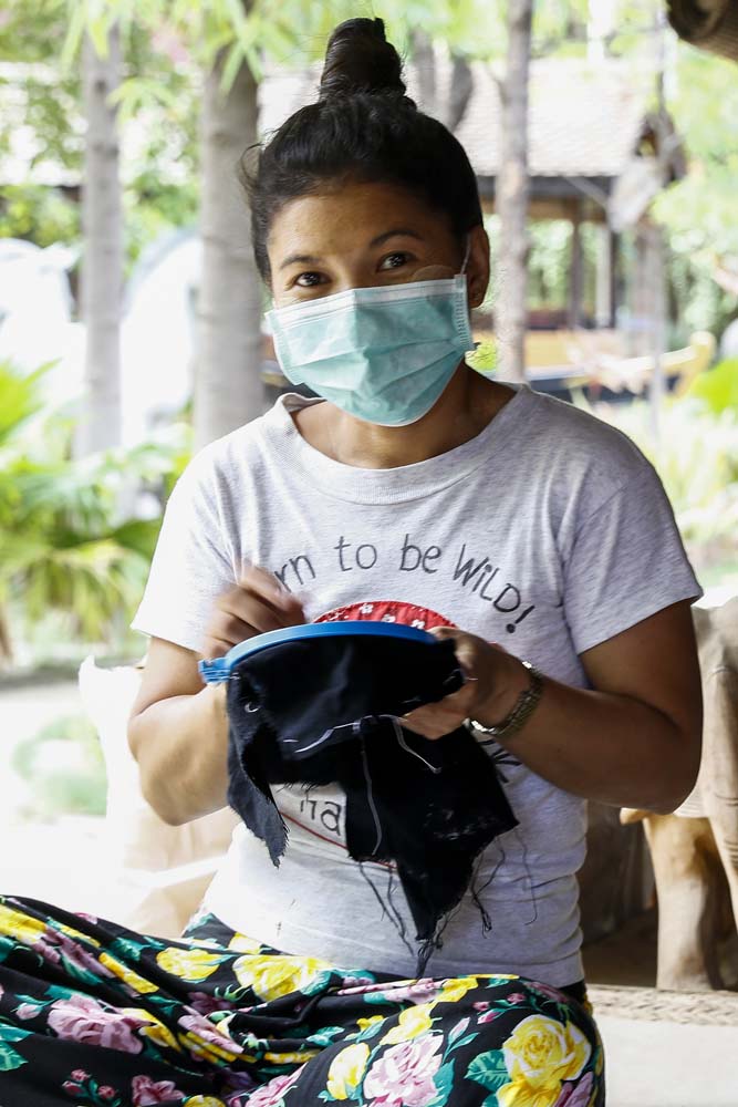 Ma Thandar earns a reduced daily wage of K3,500 at Bagan House Lacquerware sewing face masks featuring traditional floral designs. (Nyein Su Wai Kyaw Soe | Frontier)