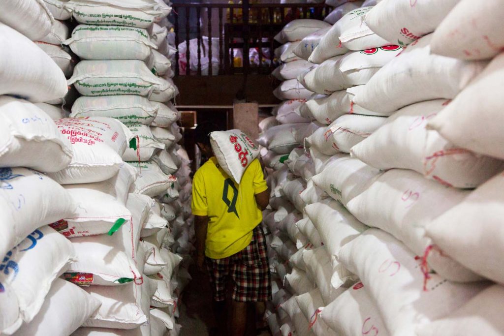 A worker at a rice warehouse in Insein Township. (Thuya Zaw | Frontier)