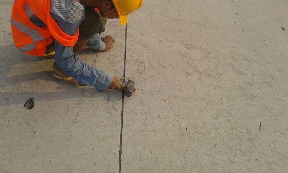 A Ministry of Construction worker repairs cat’s eyes on the Yangon-Mandalay Expressway. (Supplied)
