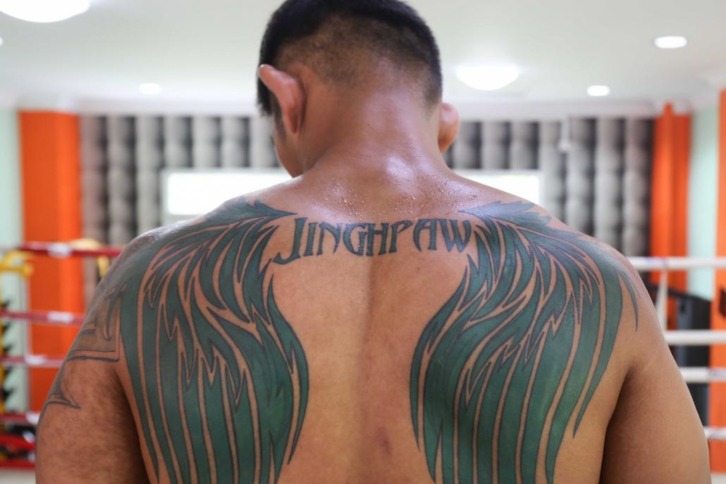  /></p><p>But all that anonymity disappears in Myanmar, where he’s won two ONE Championship fights and signed sponsorship deals with a litany of local brands. Fame creates a strange paradox: A man who bears tattooed wings on his back that symbolise freedom for the Kachin people is often asked for selfies by police and soldiers from the same military waging war on the KIA and accused of abuses against civilians.</p><p>After his most recent victory, over Michal Pasternak in October 2016, Aung La Nsang used his platform to address the conflict.</p><p>“It makes me very sad that there is war in Kachin,” he said in Myanmar language to the crowd. “We need to get along and work together if we want a better future for this country.”</p><p>If he wins again on June 30, he’ll earn his first world title in front of several thousand screaming Myanmar fans.</p><p>“A lot of things that I do, the fighting … it’s to encourage the Kachin people, my people,” he said. “Everything that I do is to let them know that I’m just a guy from Myitkyina.”</p><h3><strong>Boyhood roots</strong></h3><p>Hkawng Dau worked for five years as an education officer at Mai Na, a camp in Myitkyina set up for people displaced by the conflict. He remembers the first time he saw footage of Aung La Nsang: the 2012 video, the first round knockout, the Kachin flag. He also recalls how the fighter promised to use 25 percent of his winnings to support IDPs.</p><p>Fast forward to 2017. A household name in his home country, Aung La Nsang harnessed his newfound fame to host a charity auction in March to raise money for the camps. After selling off old gloves, medals, autographed T-shirts and even a private dinner, he returned to Myitkyina for the first time in 14 years and delivered US$6,000 worth of aid to refugees at Mai Na.</p><p>He admitted that the rush of adoring Kachin fans overwhelmed him at first.</p><p>“It was full of families, and there were a lot of kids too,” he said. “They don’t have it as good as us, and it’s just nice to know that I was able to help.”</p><p>Hkawng Dau, who met Aung La Nsang for the first time during the visit, said he was grateful both for the assistance and show of solidarity with the IDPs.</p><p>“He sold his trophies and awards to help the IDPs,” Hkawng Dau said. “He shares mutual feelings with us – that’s why we are more attached to him.”</p><p>They appreciate his support for Kachin people – but they also appreciate the fact that he is Kachin himself, a rare international icon from a region that few outsiders can place on a map.</p><h2 class=