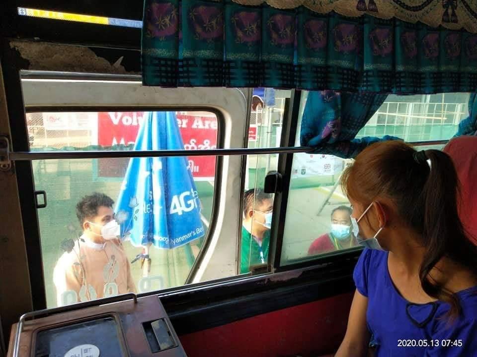 A returning migrant worker looks out from a bus at Myawaddy bound for Bago Region, where she will undergo 21 days' quarantine, on May 13. (Supplied)