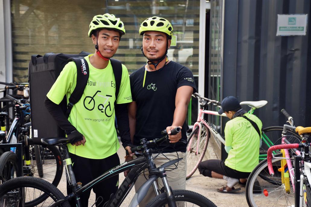 Than Zaw and his supervisor, Hong Phyo Wai, at the Yangon headquarters of food delivery service Yangon Door2Door. (Steve Tickner | Frontier)