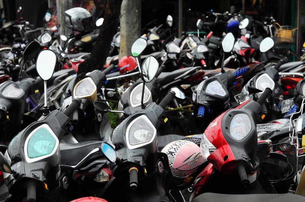  /></p><p>A particular sore point is that trishaws are licensed and their owners are required to pay a registration fee to YCDC, but they have to compete with unlicensed motorbikes.</p><p>“Licensed trishaw drivers are suffering because of unlicensed motorbike taxis,” said Ko Kyaw Zay Yar, who has been pedalling a trishaw in Hlaing Tharyar for the past three years.</p><p>“Unregistered motorbikes are rarely stopped, while licensed trishaws are frequently arrested for various reasons”, like driving in the wrong direction on a one-way road.</p><p>U Kyaw Min Oo, a member of Bicycle Network Myanmar, which aims to promote bicycle use in Yangon, also complained of an enforcement double standard.</p><p>Traffic police prohibit the use of bicycles in the downtown area and on major arterials like Pyay Road, but often turn a blind eye to motorbikes.</p><p>“When we meet members of the Yangon Region government and ask whether we can use bicycles in downtown, they can’t answer clearly,” he said. “At the same time, motorbikes are prohibited in Yangon but almost every household has one.”</p><h3><strong>Time for a rethink?</strong></h3><p>Given that police are clearly unable to enforce the motorbike ban – and in many areas are simply ignoring motorbikes use – is it likely that the ban will be lifted? </p><p>The government has so far given no indications that it is reconsidering. But some are calling for at least a partial relaxation on the ban on motorbikes.</p><p>U Kyaw Nyi Nyi, a resident of Thanlyin Township, said allowing motorbikes could help to solve Yangon’s traffic jam problems.</p><p>While some argue that motorbikes would not reduce car usage because car users were unlikely to downgrade to a motorbike, Kyaw Nyi Nyi said many would be tempted because of the time that could be saved. When traffic is heavy, motorbikes can normally weave around idling cars.</p><p>“When I go from Thanlyin to Thaketa by car, it takes more than an hour. If I go by motorbike, it takes just 10 minutes,” he said. “But we should also try to learn from Mandalay and Mawlamyine, where there are many motorbikes.”</p><p>Daw Thandar Moe, a Yangon Region Hluttaw MP for Mingaladon 2, said she would lobby the government to allow motorbikes in her constituency.</p><p>“Although Mingaladon is in the YCDC area, there are many villages that are far from the main road,” she said, adding that she could not provide more information because MPs were forbidden from discussing questions and proposals before they were formally submitted to parliament. “I’m hoping for the best.”</p><p>She has an ally in U Htun Htun Win, the other regional MP for Mingaladon. “My quarter is nearly 1 mile [1.6 kilometres] from the nearest bus stop. A motorbike is the only vehicle for people who can’t afford to buy a car,” he said. “I don’t think the government will agree easily, but we should at least ask [for permission].”</p><p><em><strong>Top photo: Steve Tickner / Frontier</strong></em></p></body>