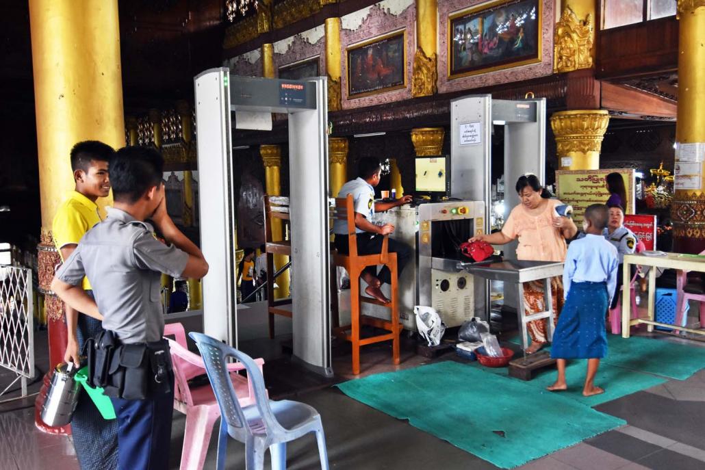 Security guards screen bags and visitors at the entrance to Shwedagon Pagoda in Yangon. (Steve Tickner | Frontier)