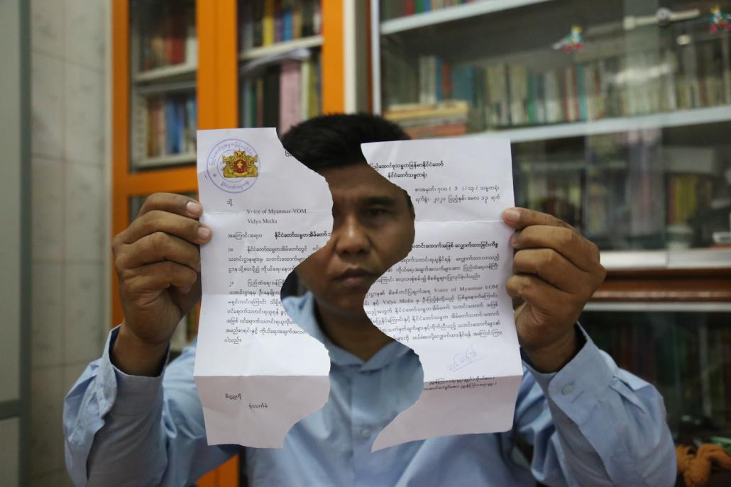 Ko Nay Myo Linn, chief editor of Mandalay-based Voice of Myanmar, holds up his rejected application to register to cover the President's Office. The torn application was returned to him after he was released in early April. (Kaung Zaw Hein | Supplied)