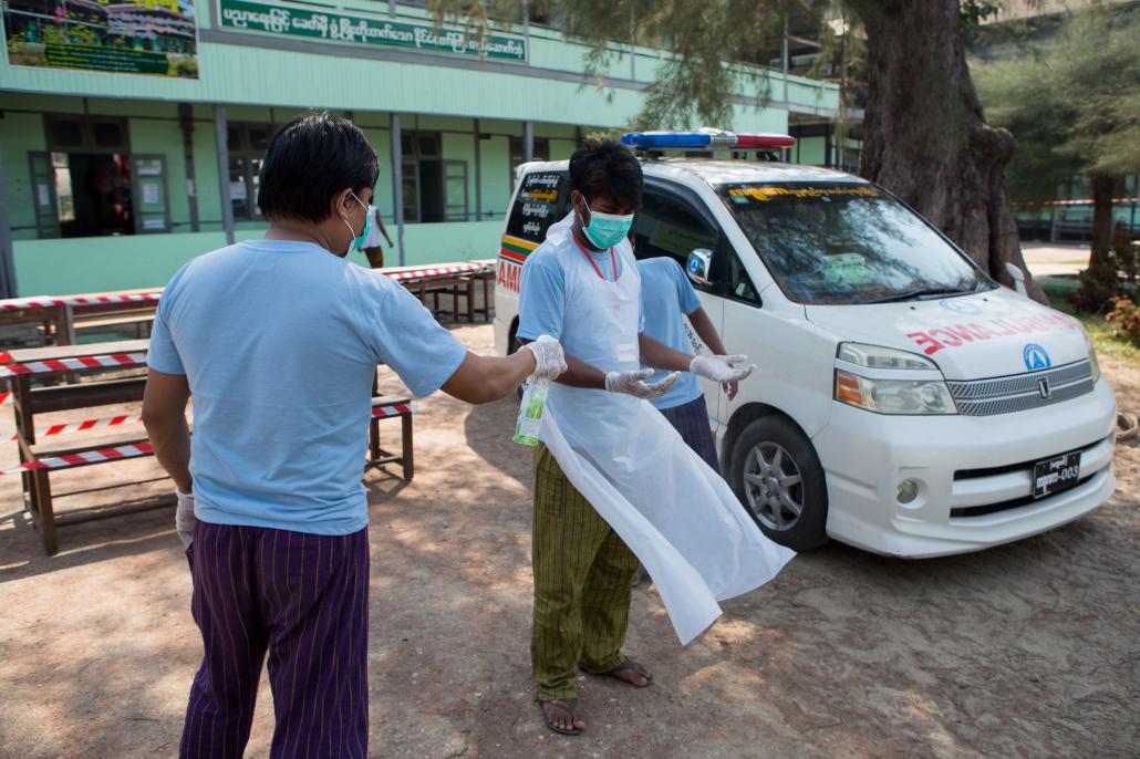 Volunteers at a quarantine centre in the Ayeyarwady Region town of Maubin, which on April 4 was hosting 18 returned migrants from China and one from Thailand. (Thuya Zaw | Frontier)