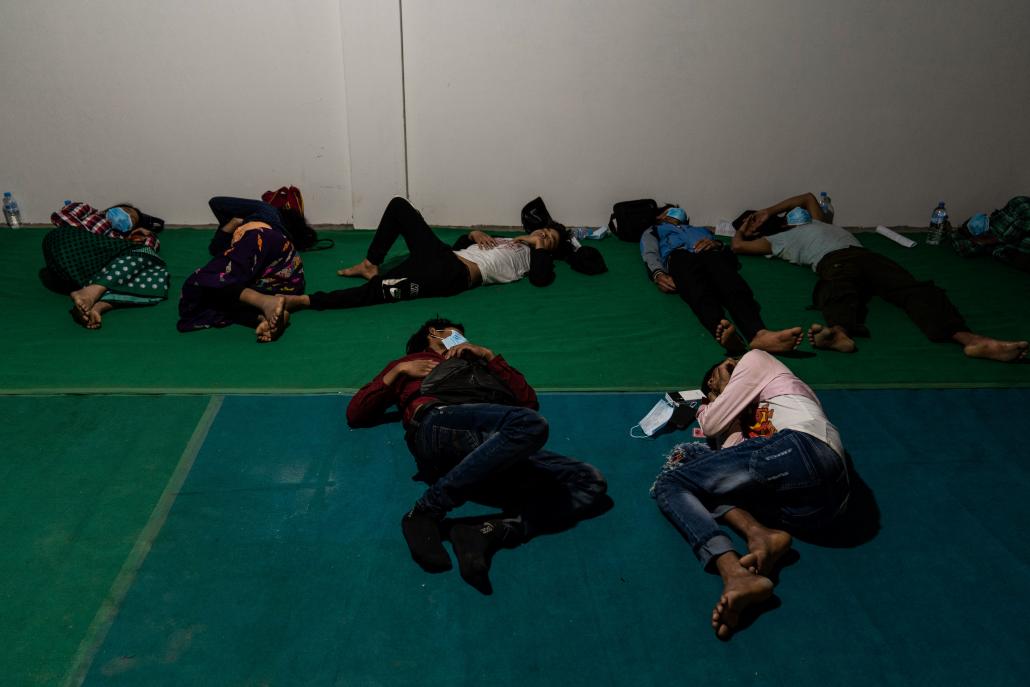 Migrant workers returned from China spend the night of April 16 at the transit centre in Myitkyina before being taken to quarantine facilities in their home towns and villages. (Hkun Li | Frontier)