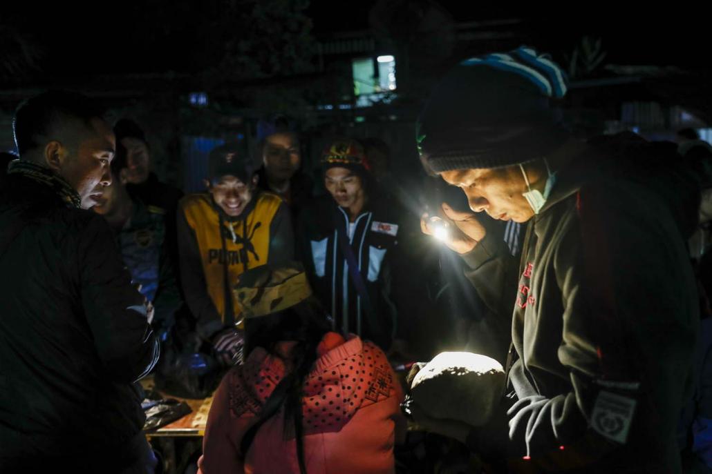 Raw jade is sold at a night market in Hwekha. (Nyein Su Wai Kyaw Soe | Frontier)