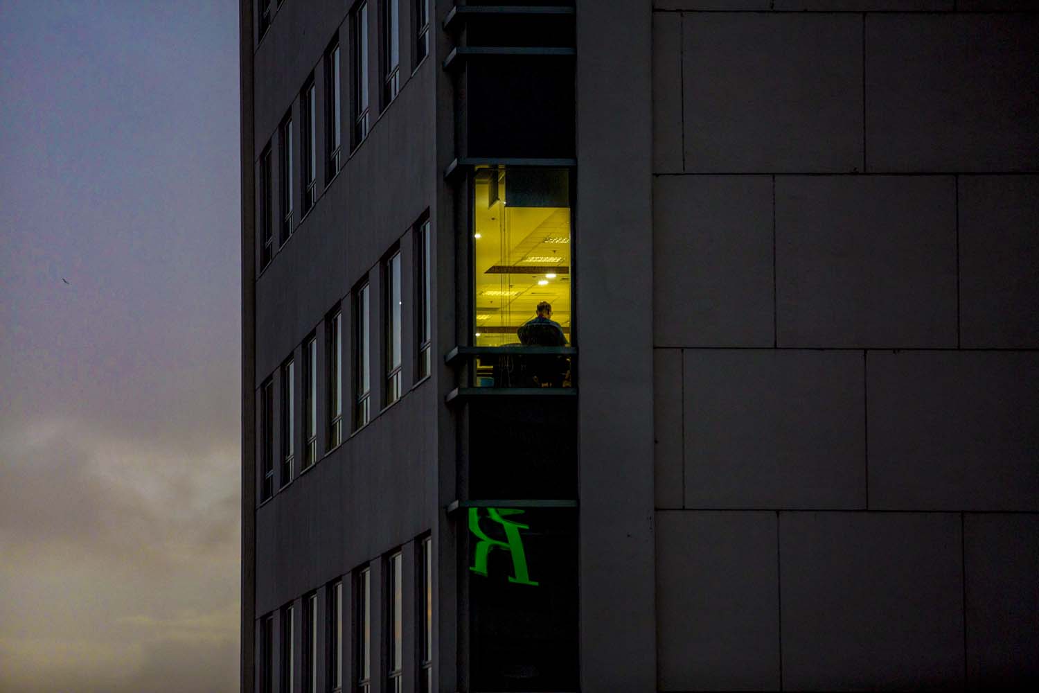 An office worker inside Sule Square in downtown Yangon on the evening of July 10. (Hkun Lat | Frontier)