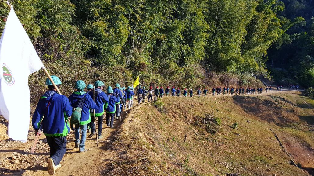 Pat Jasan volunteers march along the Chipwi road in rural Waingmaw Township during a mission to destroy poppy fields in 2016. (Supplied)