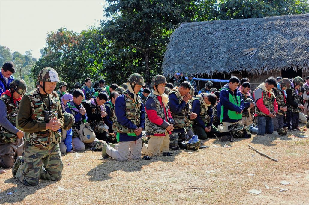 Pat Jasan volunteers pray during a mission to eradicate poppy fields in 2016. (Supplied)